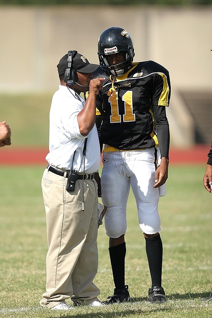 Football team strategizing on the sideline during a critical match