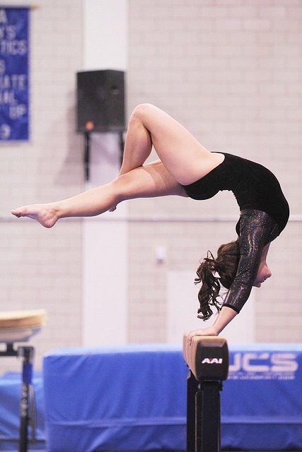 Gymnast performing a routine on the balance beam with intense focus