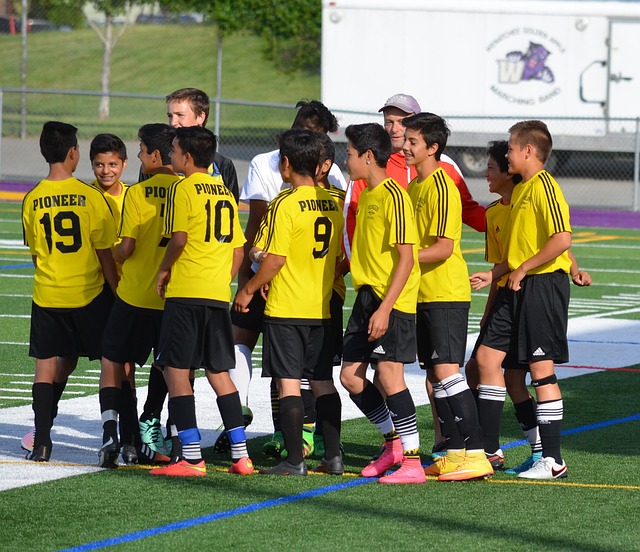 Team lifting coach in celebration after winning a major cup
